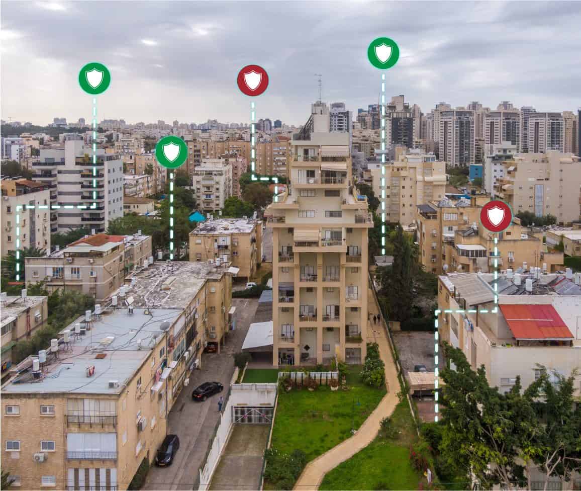 Aerial view of a city with green and red shield-status pins over every shelter location