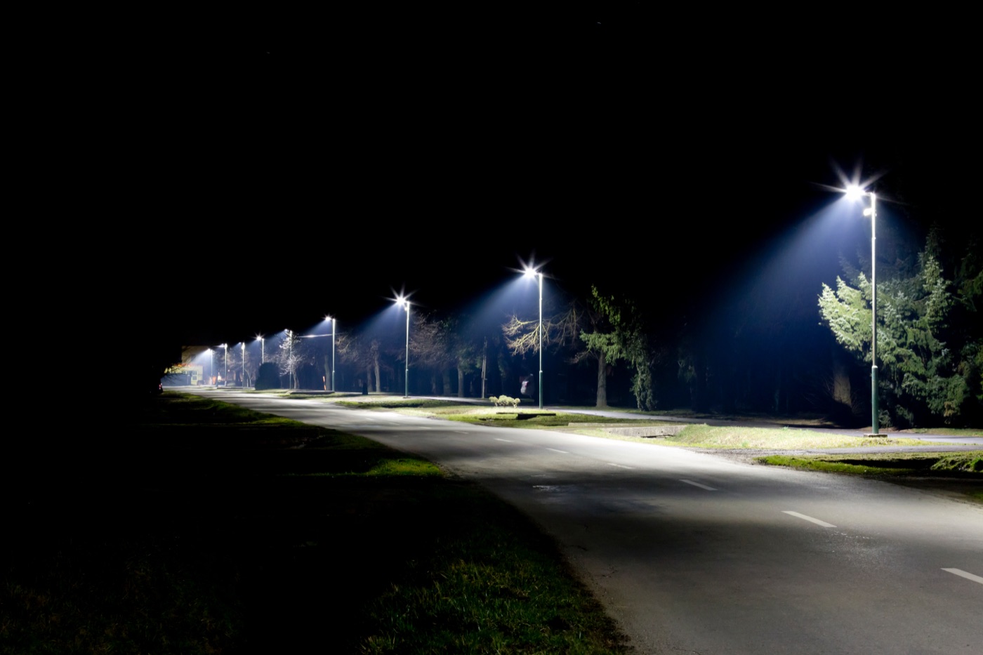 Row of illuminated street lights at night
